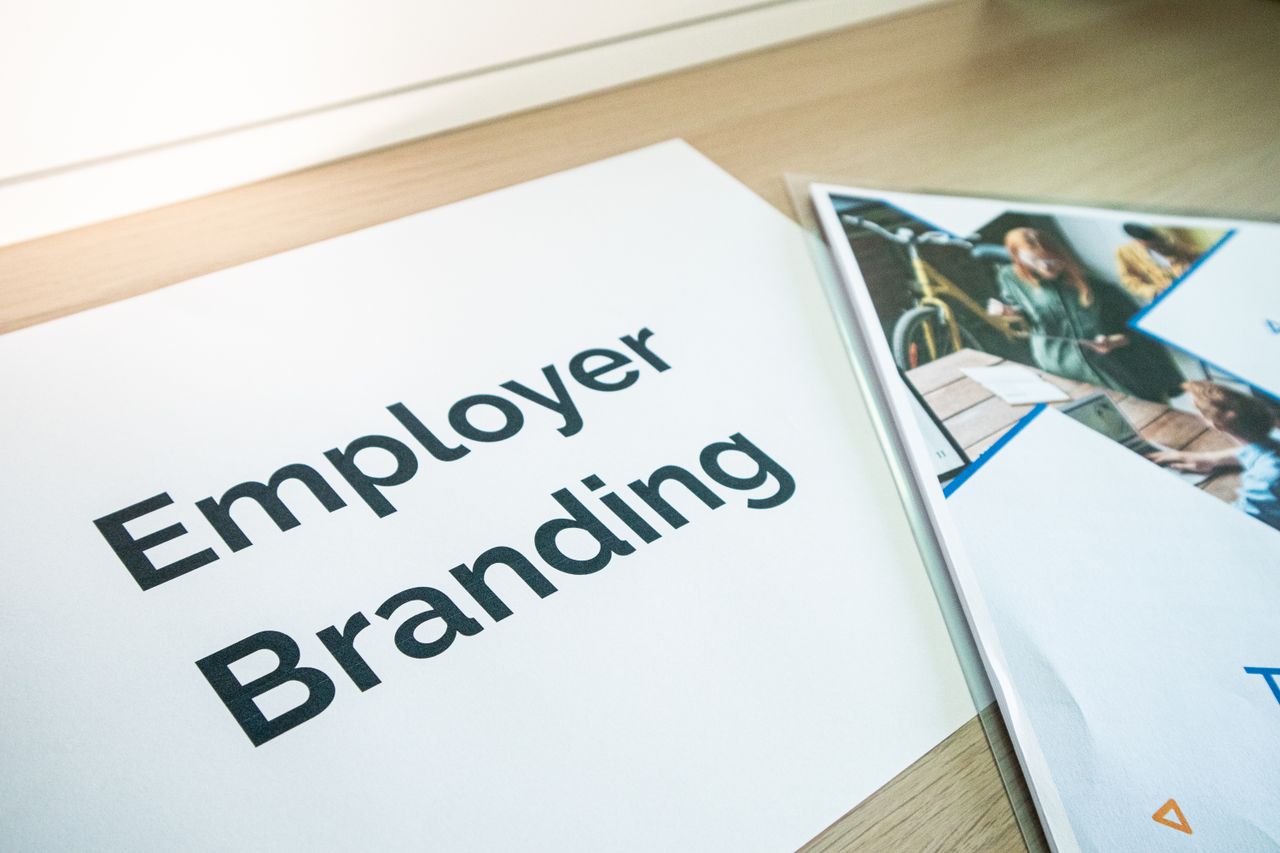 about-01 Focus on employer branding with documents on a wooden desk, ideal for business concepts.